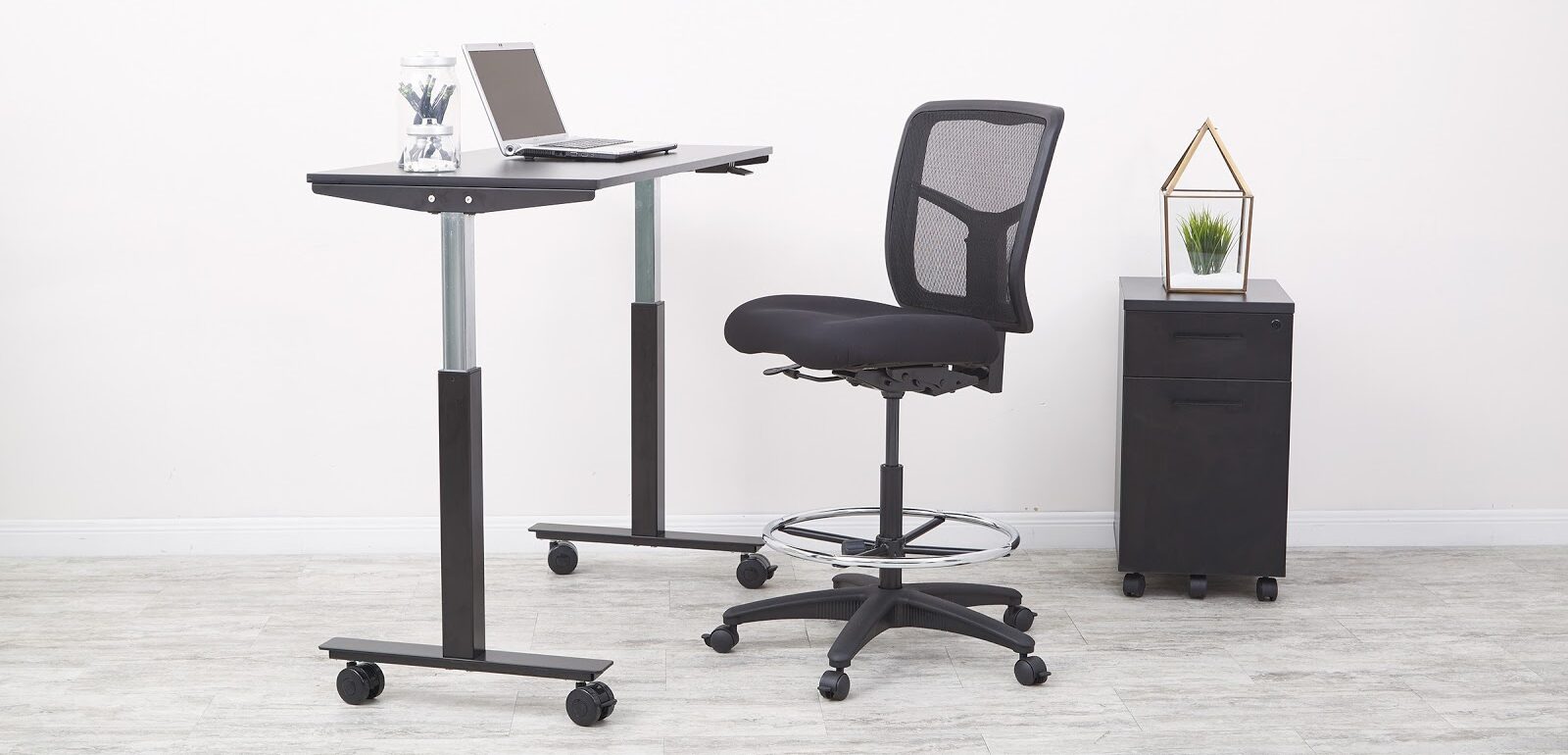 an adjustable standing desk with adjustable chair and small movable cabinet